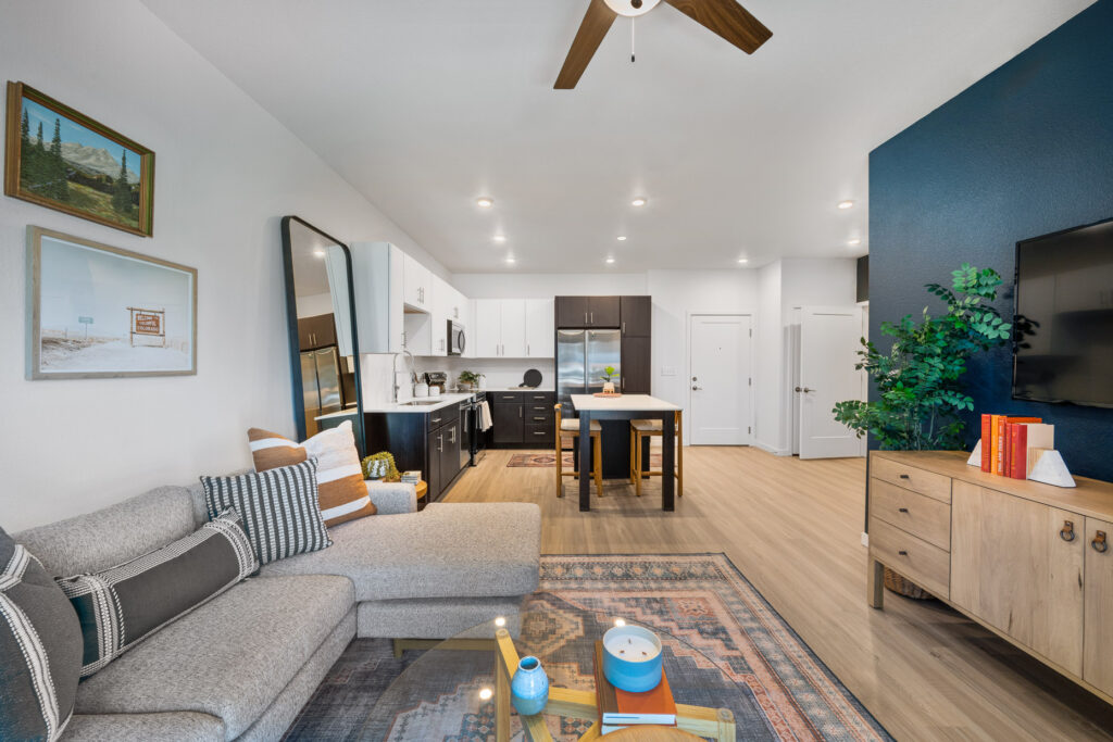 Spacious living room, kitchen, and dining area in new apartment in Denver at Vine at Panorama