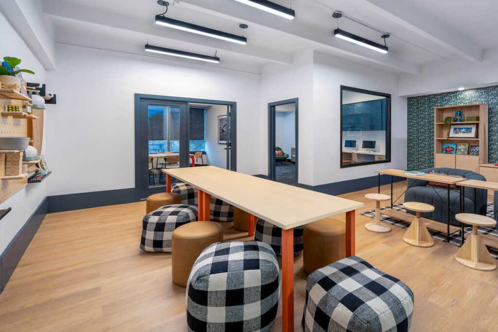 children's learning space with dining tables and ottoman stools